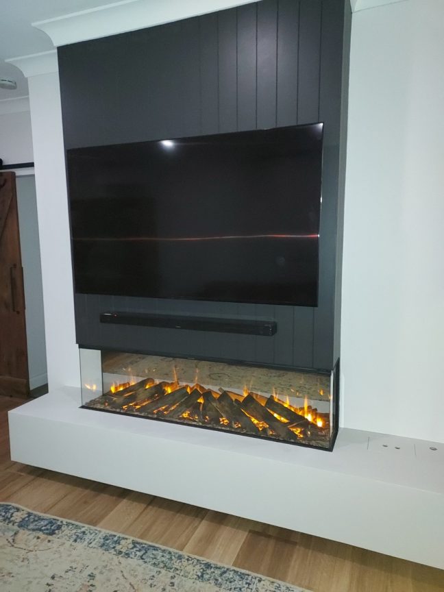 Clearview Carpentry built Flue for glass fireplace with mounted TV above
